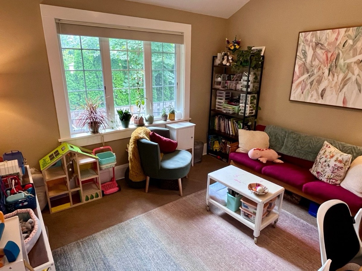 The Storytellers therapy office, a cozy room with colorful furniture and toys by the window